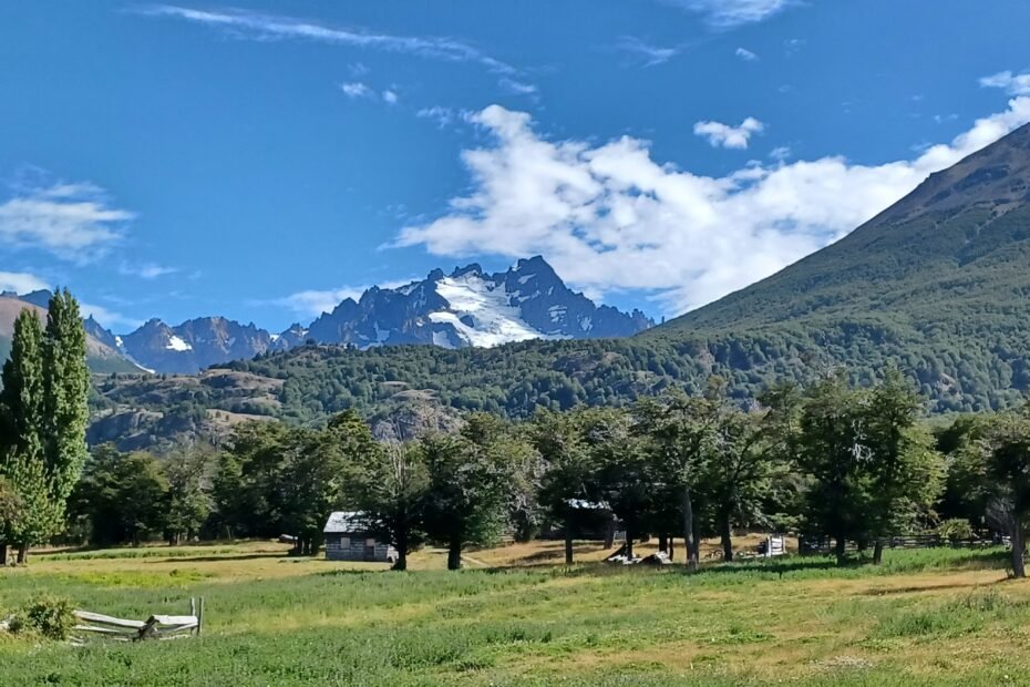 A farm in front of the mountains